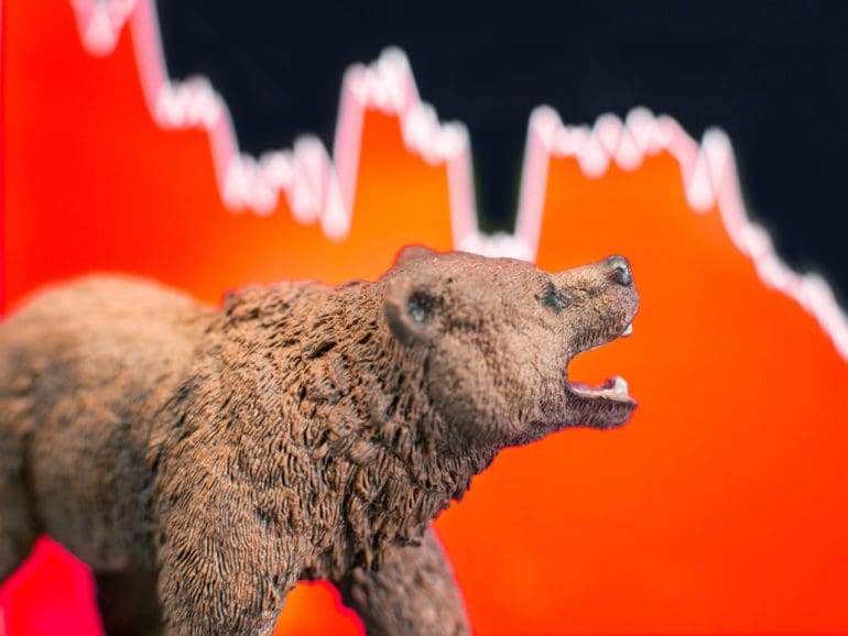 Bearish scenario in stock market with bear figure in front of red price drop chart.