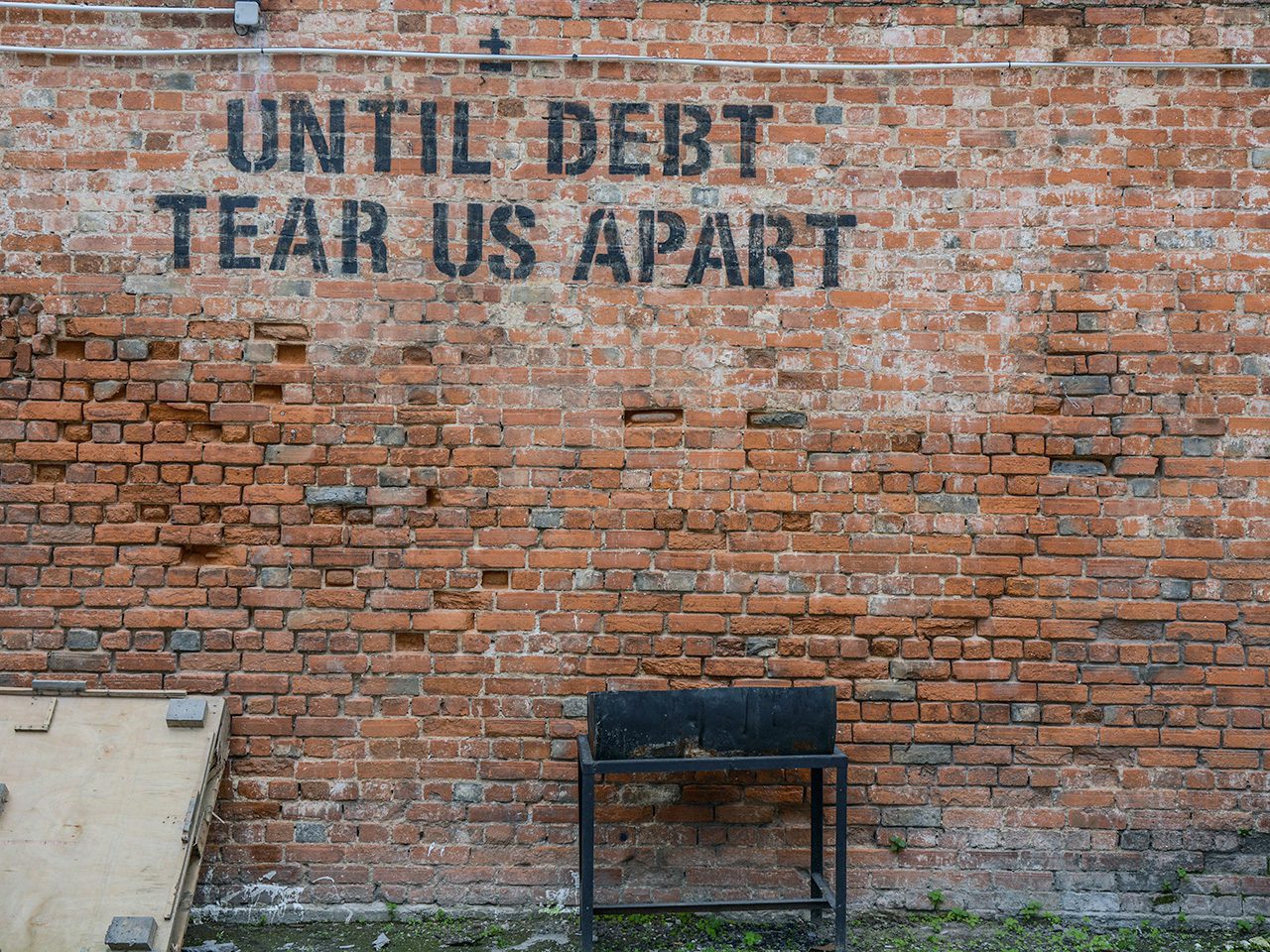 Until debt tear us apart sign