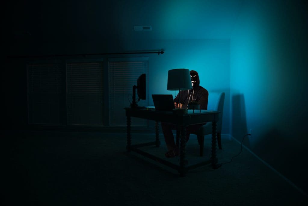 man on computer in dark room
