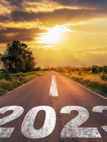 Empty asphalt road and New year 2023 concept. Driving on an empty road to Goals 2023 with sunset.