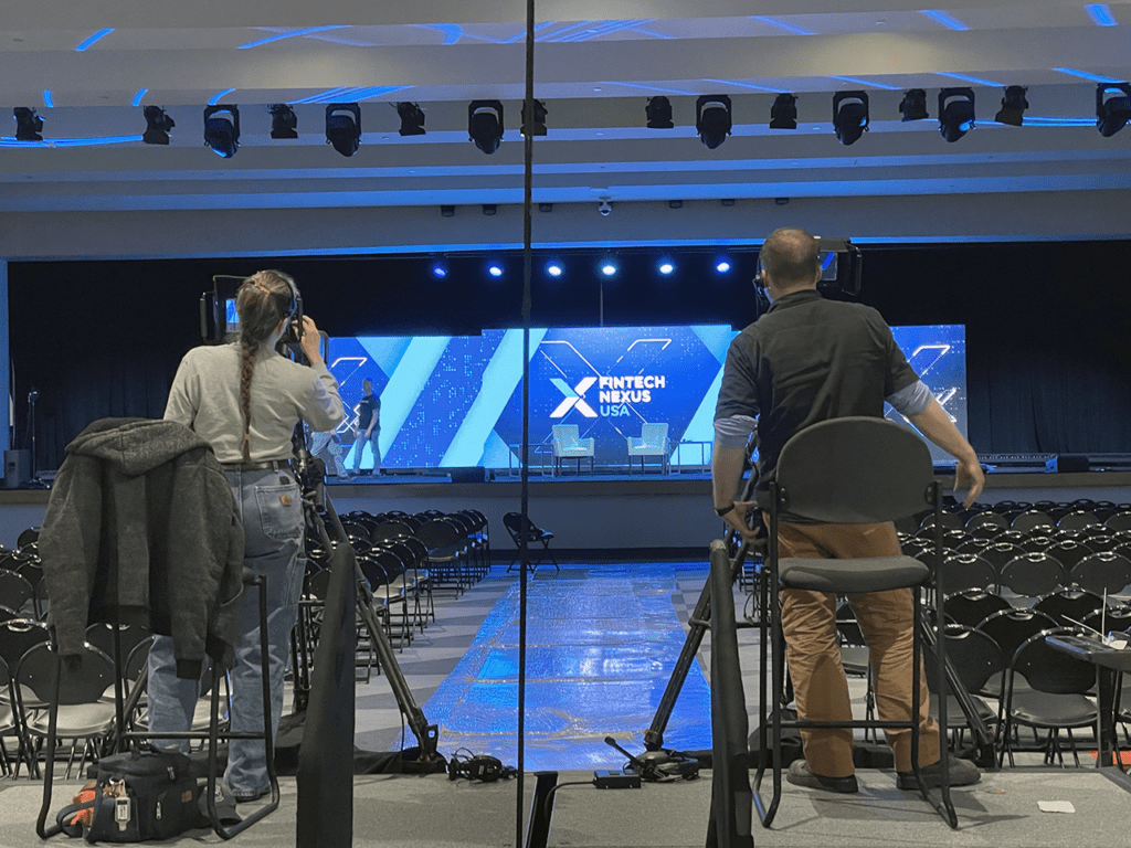 Camera operators practice their shots at the main stage of Fintech Nexus USA 2023 at the Javits Center on May 9, 2023. | John K. White, Fintech Nexus
